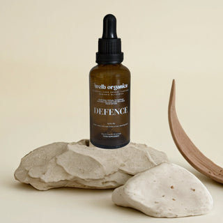 Bottle of 'Defence' glycerite on a stone surface with a neutral background