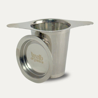 Stainless steel tea steeper on a neutral background