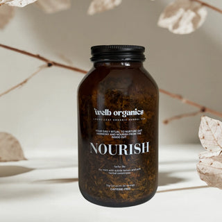 Brown jar labeled 'welb organics' with 'NOURISH' on a neutral background
