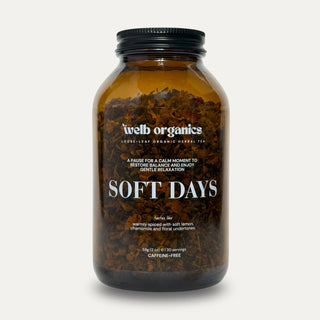 Soft Days Herbal tea blend in a brown Welb Organics apothecary jar on a neutral background